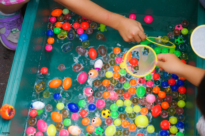 Water play as one of the simple home play ideas that teach coordination