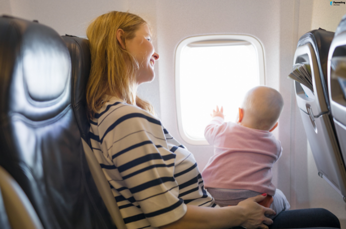 Travelling with a baby by flight while seated on a parent’s lap and looking out the airplane window