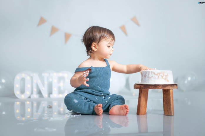 Baby enjoying cake during a simple first birthday celebration with baby-friendly setup