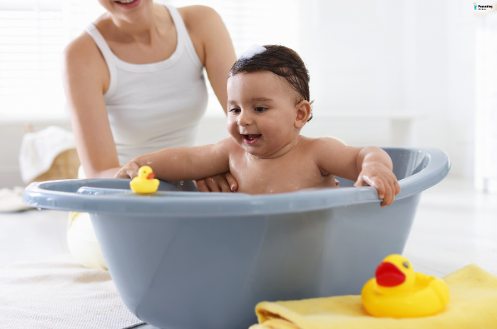 Baby enjoying a gentle bath, as part of the recommended baby skin care for summers.
