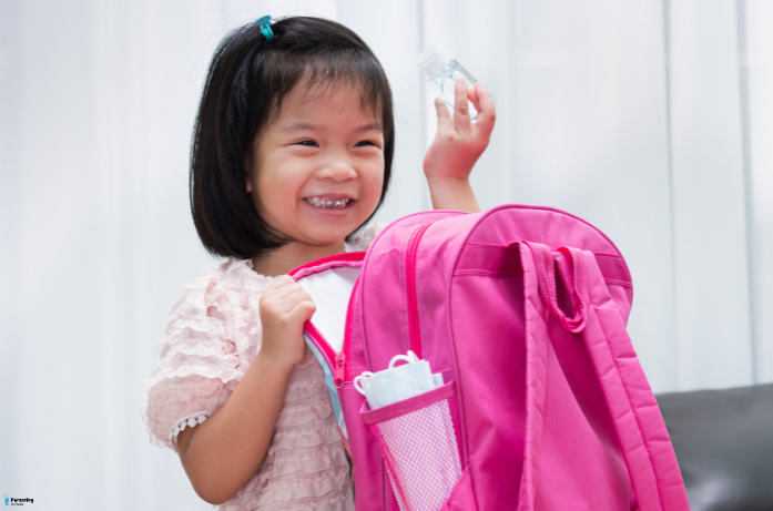 Child ready with backpack on first day, what to buy for starting school
