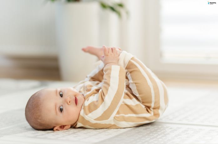 Baby wearing protective clothing to shield from the sun, reducing risk of baby skin sunburn.